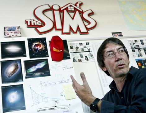 Will Wright next to the logo of his game franchise The Sims.